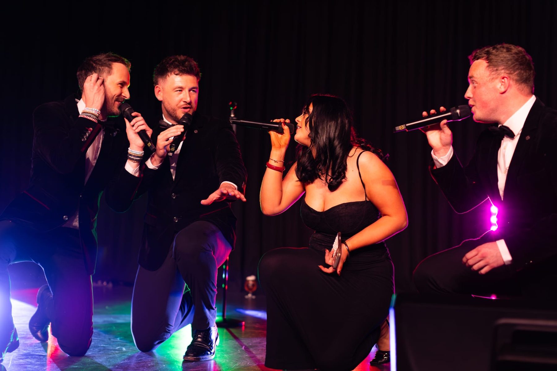 Molly Imogen performing live with a vocal group on stage